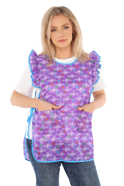 Floral pinafore apron with ruffle, two side pockets, tie-back fastening