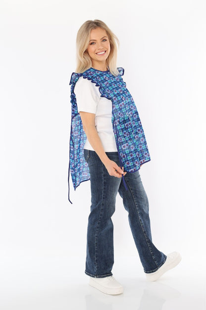 Floral pinafore apron with ruffle, two side pockets, tie-back fastening