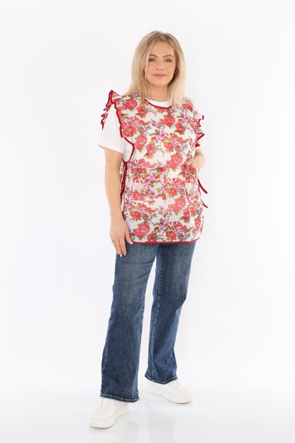 Floral pinafore apron with ruffle, two side pockets, tie-back fastening